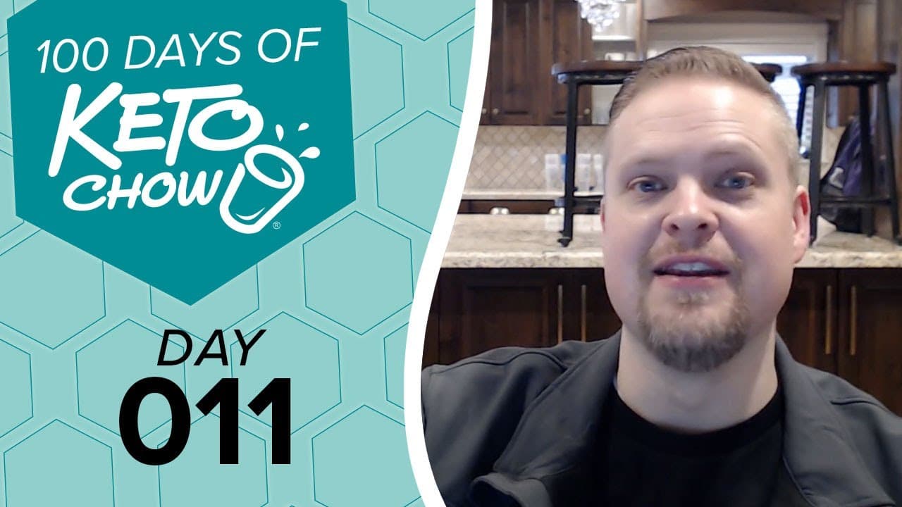 Graphic banner with 100 DAYS OF KETO CHOW, Day 011. The white Keto Chow logo and text are on a dark teal hexagon, set against a light teal honeycomb pattern. A man is seen on the right.