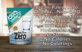 White and teal Keto Chow Zero stand-up pouch for Mega-Ultra-Super-DeDuper-Zero Carb Meal Replacement Shake Mix, displaying 0.0g Net Carbs, a glass of water, and a blue water splash graphic. The pouch features the KETO CHOW logo with make keto easy and v2.5.0. Net Wt. 13 oz (372g) and www.ketochow.xyz are visible. Overlaying the background are white text claims: Vegan, Paleo, Keto, Organic, Non-GMO, Fat Free, Sugar Free, All Natural, Gluten Free, No Sweeteners, No Flavors, No Calories, No Colorings. Smaller text at the bottom indicates it is Keto Chow Electrolyte Drops in a fake bag and mentions Happy April 1st.
