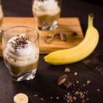 Glass with Banoffee Parfait and a banana to the side