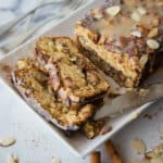 Close up of sliced cinnamon almond coffee cake on a white plate