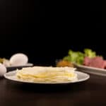 Close up - White plate with a stack of Egg White Protein Wraps.