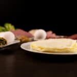 Close up - White plate with a stack of Egg White Protein Wraps.