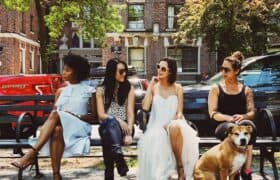 women sitting on bench