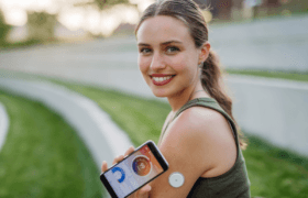 woman wearing cgm device