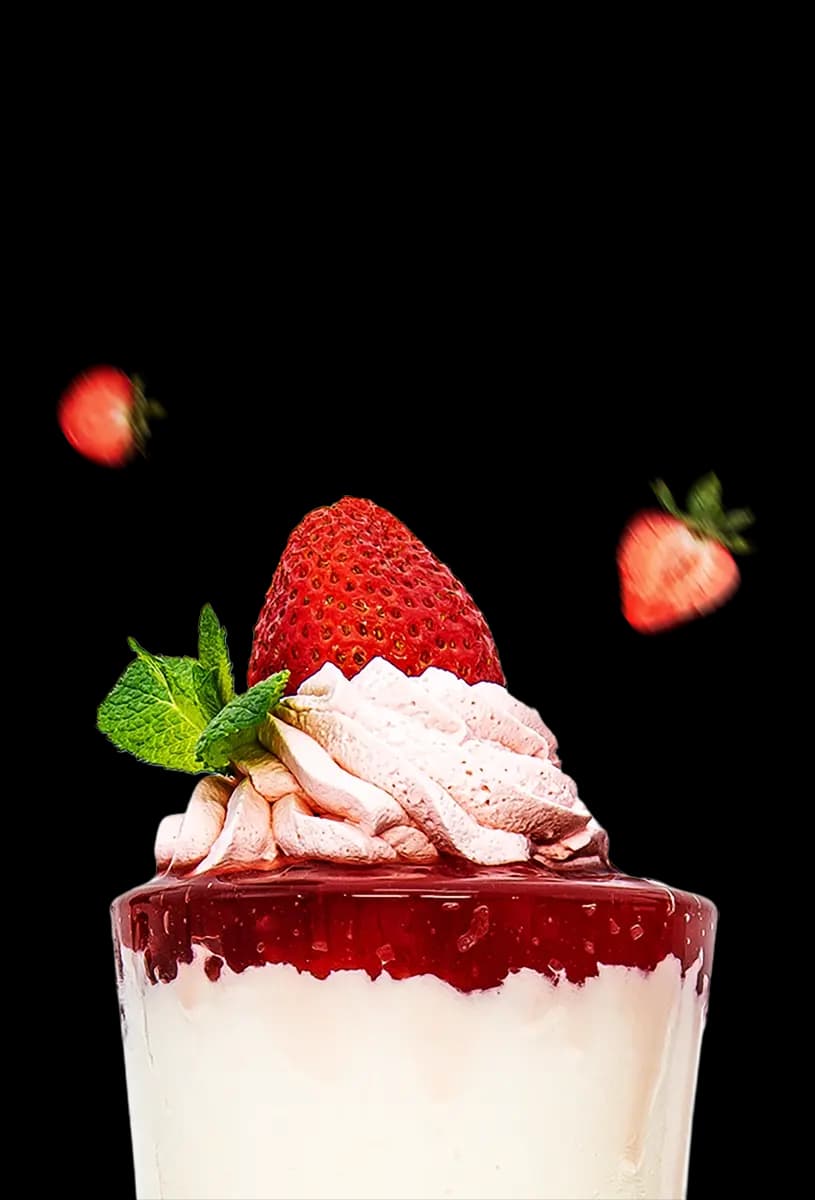 A shake topped with whipped cream and strawberries.