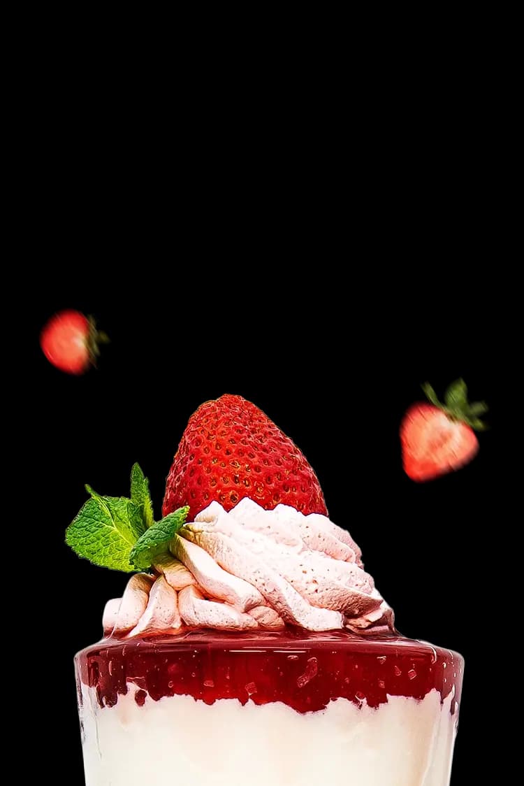 A shake topped with whipped cream and strawberries.