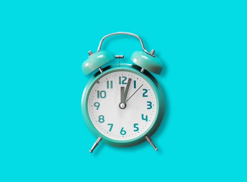A blue alarm clock on a blue background