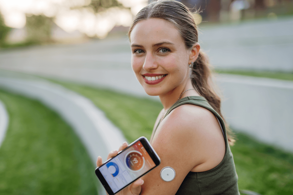 woman wearing cgm device