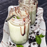 Chocolate Mint Keto Chow shake in a glass jar with straw
