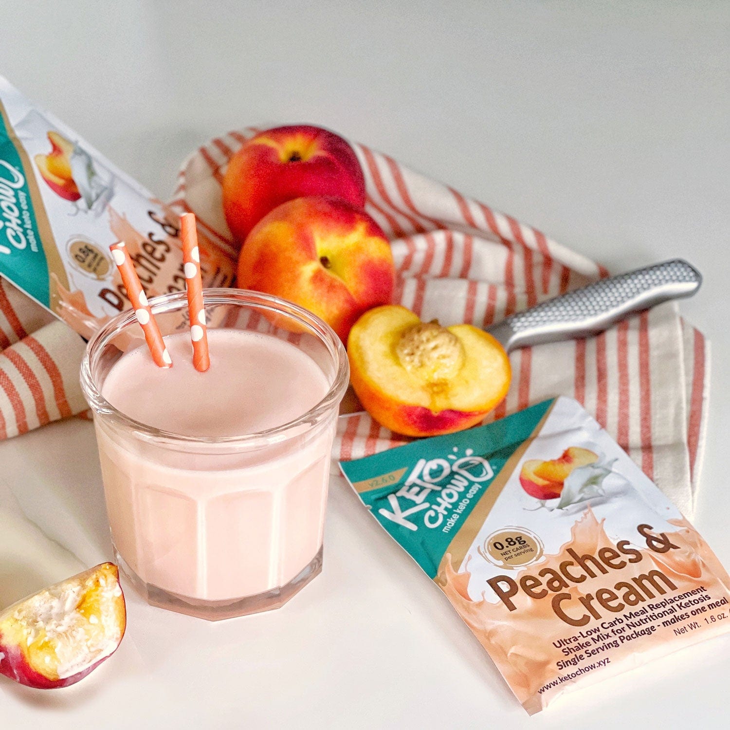 Peaches and Cream Keto Chow Single Meal Packet and shake with peaches and cooking tools in background