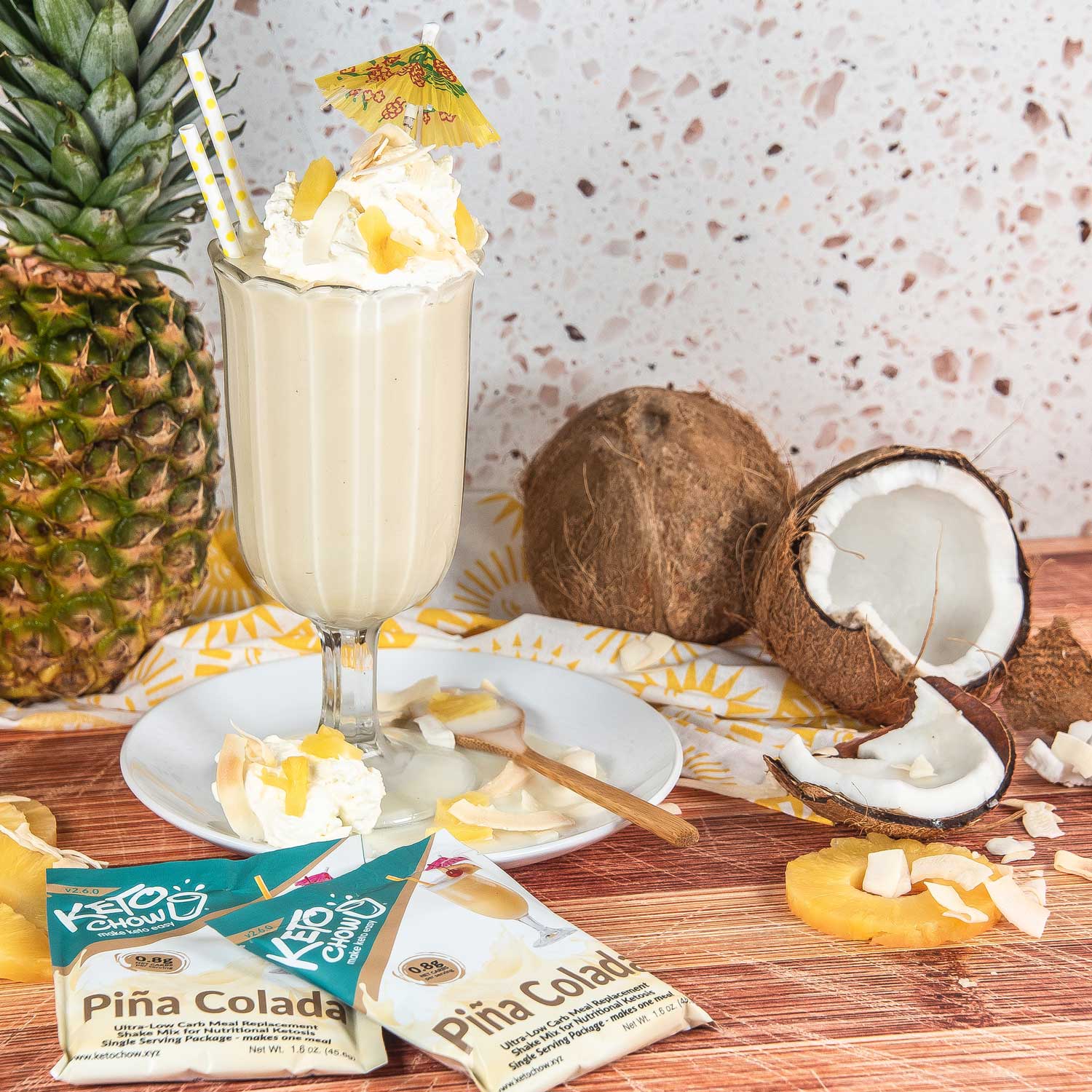  Pina Colada Keto Chow shake with coconut and pineapple around it